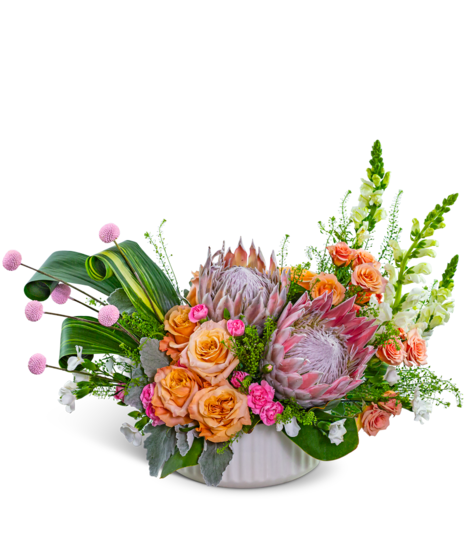 Euphoria centerpiece with King Protea, roses, snapdragons, and lush greenery in a ceramic bowl – Peoria IL luxury flowers