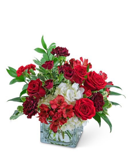 Flower Arrangement in clear square vase featuring hydrangeas, alstro, red roses, and carnations 