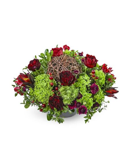 The Ruby Hour flower arrangement with deep red roses, hydrangea, mums, alstroemeria, Safari Sunset, and rustic vine accents in a modern vase.